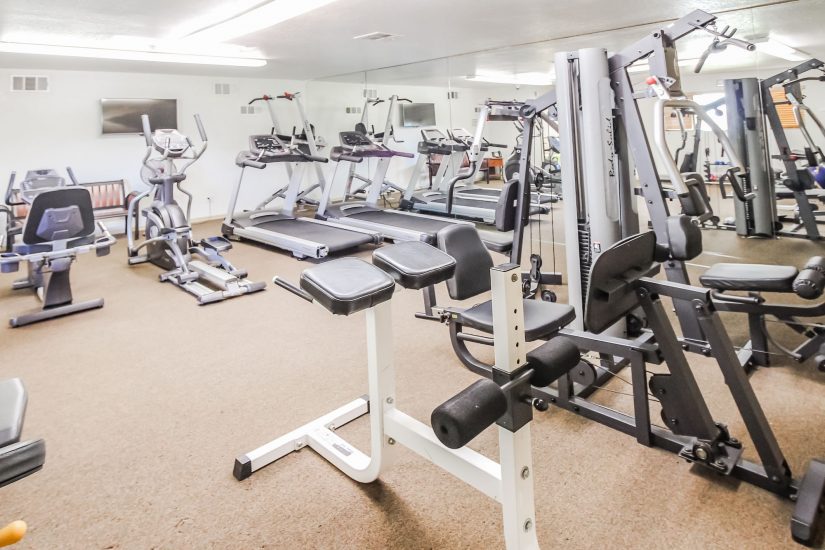 Photo of exercise room with treadmills, ellipticals, leg press and more