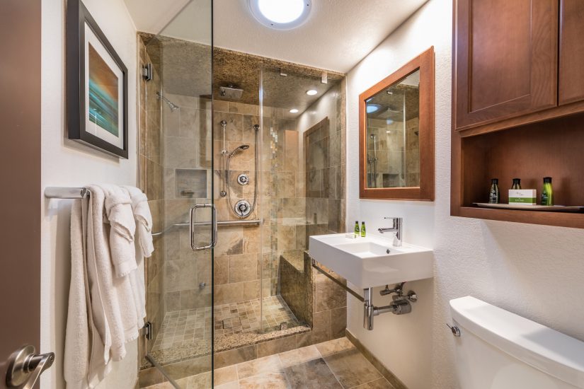 Photo of Bathroom with wooden cabinet, white sink and above head shower